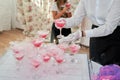 Waitress hands in gloves hold a glass with a steaming cocktail