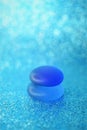 Glass stones on a shiny blue table with a blurred background in ice bubbles Royalty Free Stock Photo