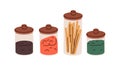 Glass storage containers with dry food products. Transparent kitchen jars covered with wood lid for spaghetti pasta