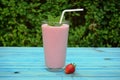 Glass of strawberries, cherries smoothie with straw on wooden table. Protein cocktail. Healthy drink. Fresh homemade smoothie. Hea Royalty Free Stock Photo