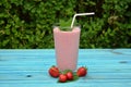 Glass of strawberries, cherries smoothie with straw on wooden table. Protein cocktail. Healthy drink. Fresh homemade smoothie. Hea Royalty Free Stock Photo