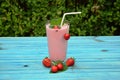 Glass of strawberries, cherries smoothie with straw on wooden table. Protein cocktail. Healthy drink. Fresh homemade smoothie. Hea Royalty Free Stock Photo