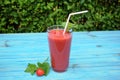 Glass of strawberries, peach smoothie with straw on wooden table. Protein cocktail. Healthy drink. Fresh homemade smoothie. Health