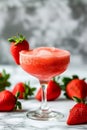 A glass of strawberry daiquiri cocktail and fresh strawberries on the table Royalty Free Stock Photo