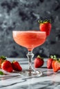 A glass of strawberry daiquiri cocktail and fresh strawberries on the table Royalty Free Stock Photo