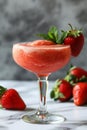 A glass of strawberry daiquiri cocktail and fresh strawberries on the table Royalty Free Stock Photo