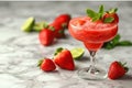 A glass of strawberry daiquiri cocktail and fresh strawberries on the table Royalty Free Stock Photo