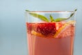 Glass of strawberry lemonade with pieces of strawberry, lemon and fresh mint. Royalty Free Stock Photo