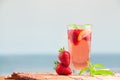 Glass of strawberry lemonade with pieces of strawberry, lemon and fresh mint. Royalty Free Stock Photo