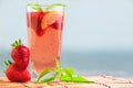 Glass of strawberry lemonade with pieces of strawberry, lemon and fresh mint. Royalty Free Stock Photo