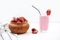 Glass with strawberry smoothie and strawberries on wooden background. Royalty Free Stock Photo