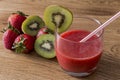 A glass strawberry of strawberry juice with kiwi