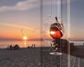 Glass of strawberry water with ice and icecream on woodentable at beach restoran view from glass door modern architecture