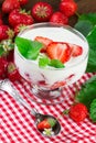 Glass with strawberry yogurt dessert. Vertical image Royalty Free Stock Photo