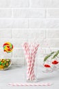 Glass with striped pink drinking straws brick wall background Royalty Free Stock Photo