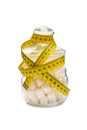 Glass sugar bowl filled with sugar cubes and wrapped by tape measure Royalty Free Stock Photo