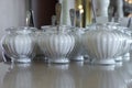 Glass sugar bowls with sugar are on the table