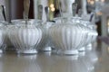 Glass sugar bowls with sugar are on the table