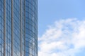 Glass surface of a building with reflection and blue sky with a cloud Royalty Free Stock Photo