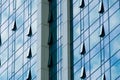 The glass surface of the facade of a modern skyscraper with ajar ventilation windows. Futuristic building shapes. The Royalty Free Stock Photo