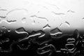 Glass surface with water drops, black and white color, shiny drops texture, wet background, monochrome gray dark to light gradient Royalty Free Stock Photo