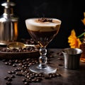 Glass of sweet coffee latte cocktail with caramel syrup and cinnamon served on table, coffee beans on dark background Royalty Free Stock Photo