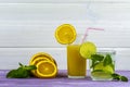 A glass of sweet freshly squeezed orange juice and a glass of Mojito with ice. Sprig of mint and orange slices Royalty Free Stock Photo