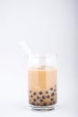 A glass of sweet milk bubble tea with tapioca pearls, and straw on white background. Copy space Royalty Free Stock Photo