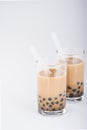 A glass of sweet milk bubble tea with tapioca pearls, and straw on white background. Copy space Royalty Free Stock Photo