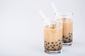 A glass of sweet milk bubble tea with tapioca pearls, and straw on white background. Copy space Royalty Free Stock Photo