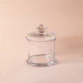 Glass sweets jar on a beige background