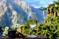 Glass of swiss or savoy dry white wine, pure chocolate with Alpine mountains peaks on background Royalty Free Stock Photo