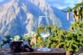 Glass of swiss or savoy dry white wine, pure chocolate with Alpine mountains peaks on background Royalty Free Stock Photo