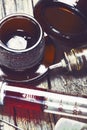 Glass syringe and the dark vial on the wooden background Royalty Free Stock Photo