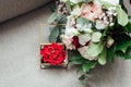 On the glass table in the room is a box with wedding rings, next to it is a bouquet of flowers Royalty Free Stock Photo