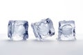 a glass table with three melting ice cubes on a white background Royalty Free Stock Photo