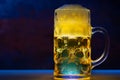 Glass tankard of golden ale on a counter