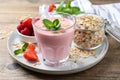 Glass of tasty berry smoothie with oatmeal on wooden table