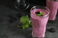 Glass of tasty blackberry smoothie on grey . Space for text Royalty Free Stock Photo