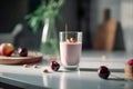 Glass of cherry almond smoothie for breakfast on sunny morning in the kitchen