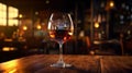 Glass of tasty cognac on wooden table in bar, closeup Royalty Free Stock Photo