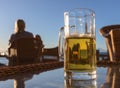 Glass of tasty cold beer, standing on a table of a beach bar. Royalty Free Stock Photo