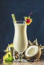 Glass of tasty Frozen Pina Colada Traditional Caribbean cocktail decorated by slice of pineapple and cherry, served on dark wooden Royalty Free Stock Photo