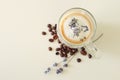 Glass with tasty lavender coffee on light background