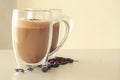 Glass with tasty lavender coffee on light background