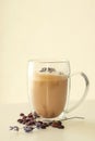 Glass with tasty lavender coffee on light background