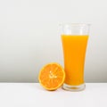 The glass of tasty pure orange juice and fresh orange half Royalty Free Stock Photo