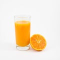 The glass of tasty pure orange juice and fresh orange half Royalty Free Stock Photo