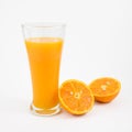 The glass of tasty pure orange juice and fresh orange half Royalty Free Stock Photo