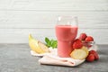 Glass with tasty strawberry smoothie and fresh fruits Royalty Free Stock Photo